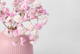 Fototapeta  - Beautiful gypsophila flowers in pink vase on white background, closeup