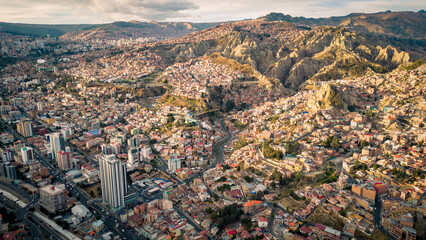 Wall Mural - Aerial Drone Fly Above La Paz, Bolivia,  Crowder Metropolitan City, Houses, Skyscrapers and Andean Cordillera Mountain Range in the Background