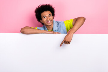 Wall Mural - Photo of glad positive man behind board wear trendy retro clothes arm direct empty space presenting news isolated on pink color background