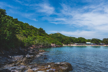 Wall Mural - Tourists at Nual Beach Koh lan Island in vacation time. Koh lan island is the Famous island near Pattaya city Thailand Nual Beach.stone beach at nual beach