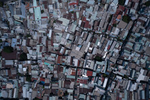 Ho Chi Minh City, Vietnam, Top Down Aerial Tracking View On A Sunny Day Featuring Rooftops Of Densely Populated Area.