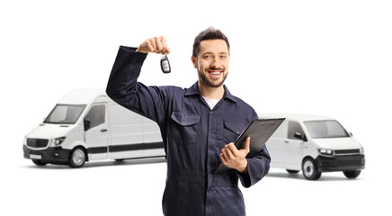 Wall Mural - Auto mechanic holding a vehicle key in front of two white vans