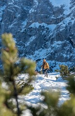 Wall Mural - Female standing in front of snow covered mountain