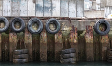 Grungy Mooring Wall With Rubber Bumpers Made Of Old Used Car Tyres