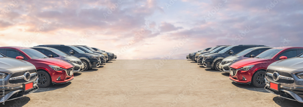 Lot of used car for sales in stock with sky and clouds