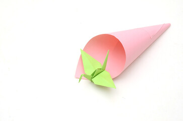 Wall Mural - Green paper bird on cone