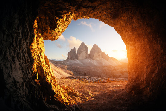 view from the cave in mountain against three peaks of lavaredo during sunset. dolomite alps, italy. 