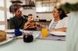 © kleberpicui - Happy grandparents having breakfast with their grandson