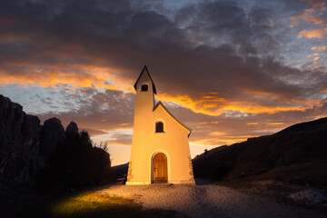 Wall Mural - gorgeus view on small iilluminated chapel - kapelle ciapela on gardena pass, italian dolomites mount