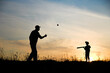 © Kostia - silhouette child with parent playing baseball concept