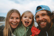 © EVERST - Family selfie parents with child outdoor mother and father with daughter happy smiling faces vacations lifestyle together