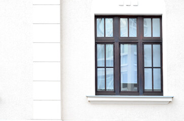 View of white building with wooden window