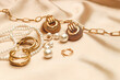 © ir1ska - Women's jewelry, gold chain, trendy jewelry on a silk background.