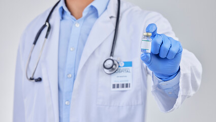 Vaccine vial, doctor and hands in studio for safety, healthcare and pharmaceutical medicine. Closeup, vaccination and bottle for virus immunity, medical antibiotics and wellness drugs on background