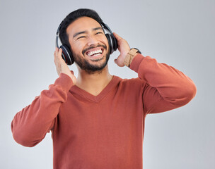 Poster - Happy asian man, headphones and music in studio with streaming, audio or web subscription by background. Student guy, listening and laughing with comic podcast, standup comedy album or hip hop single