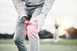 Sports, injury and golf course, black man with knee pain at game, massage and relief in health and wellness. Green, zoom on hands on leg in support and golfer with ache at golfing workout on grass.