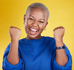 Wall Mural - Portrait, happy black woman and fist of winner in studio for celebration, achievement deal and success. Excited female model celebrate winning prize on background for lottery, bonus victory and smile