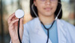 Healthcare, stethoscope and hands of doctor listen in clinic for wellness, medical care and check up. Hospital, cardiology mockup and woman worker with tools for heart disease, exam and consulting