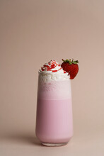 Glass of strawberry milkshake with whipped cream
