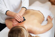 Woman having a gua sha massage in salon