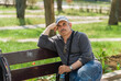 Portrait of Ukrainian ature man sitting on a bench in Feodosia town st sunny spring day