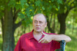 Outdoor portrait of Ukrainian mature man standing in a park at summer season
