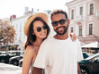 © halayalex - Smiling beautiful woman and her handsome boyfriend. Woman in casual summer clothes. Happy cheerful family. Female having fun. Sexy couple posing in the street at sunny day. In hat and sunglasses