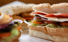 Fresh Sandwiches Prepared For Lunch In A Fast Food Restaurant. Close Up Photo Of Delicous Snacks Cooked With Sliced Meat And Vegetables