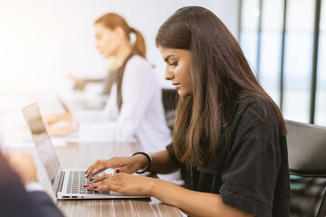 India business woman employee woking in office typing data in laptop computer