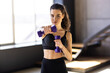 © F8  \ Suport Ukraine - Determined woman losing weight at home and exercising with dumbbells.