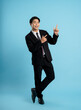 image of young businessman posing on a blue background
