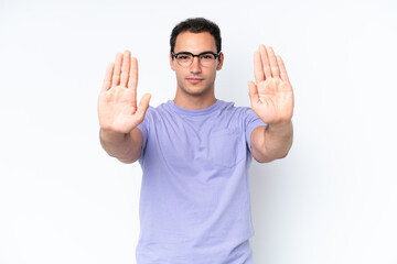 Wall Mural - Young caucasian man isolated on white background making stop gesture and disappointed