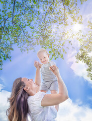 Healthy child (kid) having fun with mother in the sunny summer day at the park. Caucasians baby (boy). Healthy lifestyle, happy childhood, Mother's Day, family concept. Copy space.