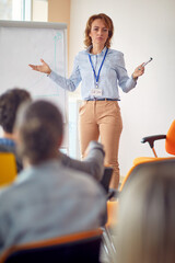 Wall Mural - A senior female businesswoman is giving a lecture in the conference room. Business, people, meeting, company