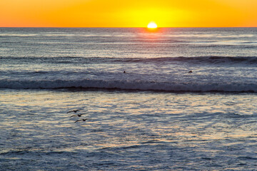 Wall Mural - Sun setting over the Pacific Ocean at El Matador State Beach in Malibu, California
