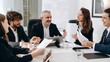 © CinemaF - Diverse team of smiling business people holding a meeting in a conference room. Business partners discuss options for the development of the company.
