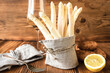 Fresh white asparagus with ingredients for a menu on rustic wood. Kitchen scene for a seasonal and healthy gastronomy concept. Close-up.