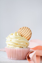 Sticker - Pink cupcakes with tall american buttercream swirl and cookie garnish, cupcakes in pink liners with a tall vanilla buttercream and a cookie, birthday cupcakes on a white background