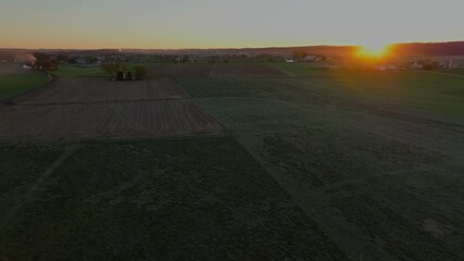 Wall Mural - Aerial Moving View of a Sunrise Over Farmlands, Barns, and Silos on an Autumn Morning