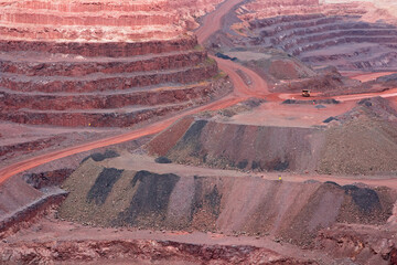 Wall Mural - Large, open-pit iron ore mine showing the various layers of soil and iron rich ore.