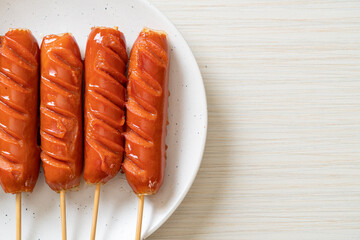 Sticker - fried sausage skewer on plate