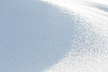 Wall Mural - light and shadow on soft white snow natural winter background
