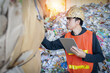 © Digital Art Studio - Asian engineer wearing hard hat and protective vest checking recycling waste while holding tablet in recycling industry, Recycling and reuse concept.