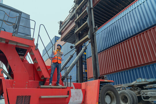 engineers are overseeing the transportation of cargo with containers inside the warehouse. container
