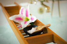 Flower With Salt Crystals In Wooden Tray For Spa Treatment