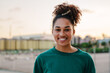 © EFStock - Young African American teenager woman smiling and looking to the camera during sunset in the city