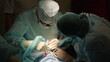 Dental surgery, dental clinic, dentist doctor and assistant in blue suits during implant operation