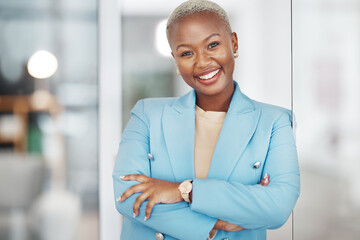 Poster - Black woman, portrait smile and arms crossed in small business management leaning on glass in modern office. Happy African American female smiling in confidence for corporate success at the workplace