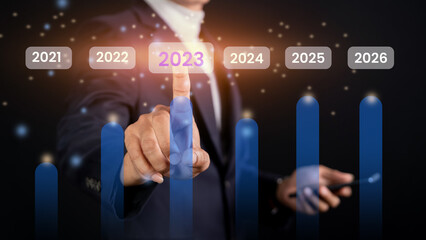 Wall Mural - future online business concept 2023. businessman touch virtual screen with 2023 icon to create effic