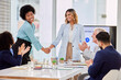 © Lune/peopleimages.com - Business people, applause and handshake in office for thank you, welcome or hiring in office. Team, collaboration and women shaking hands for integration, synergy or deal, partnership and promotion
